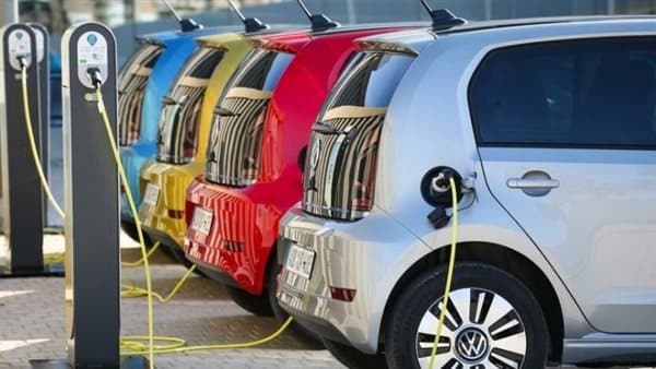 Electric vehicle at home being charged to illustrate cost savings.